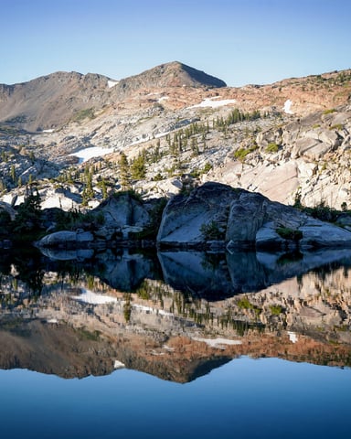 Sierra Nevada alpine lake calm reflection at dawn
