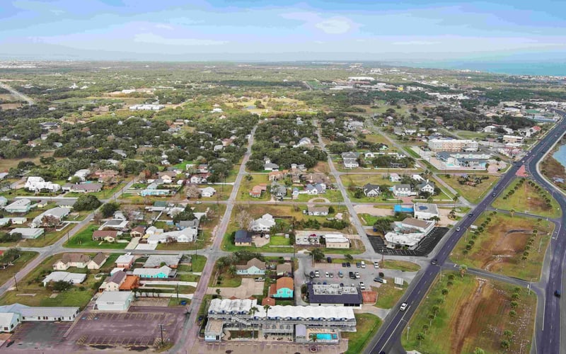 Aerial view of Blue Wave Inn and the neighborhood approaching the coast
