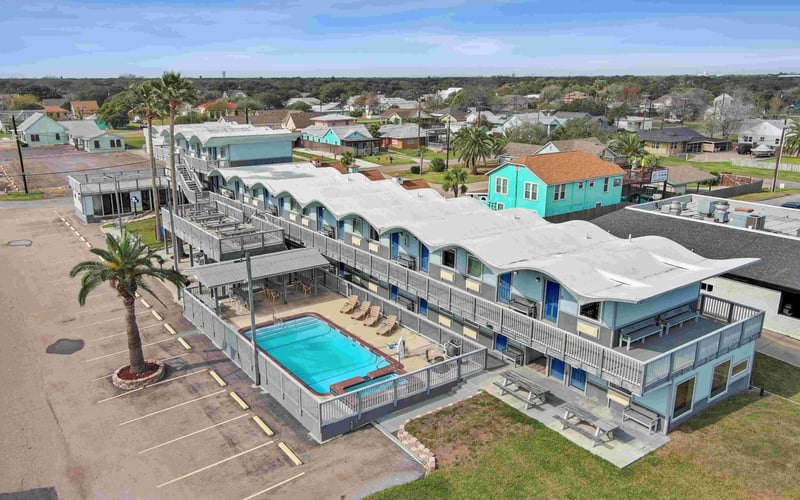 Blue Wave Inn exterior with pool and upper deck